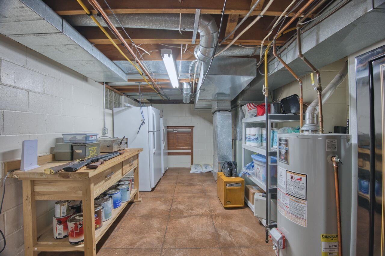 3557 Haverkamp Road Hibbing, MN 55746 - Photo 36 of 60 Unfinished basement with water heater, freestanding refrigerator, and concrete block wall