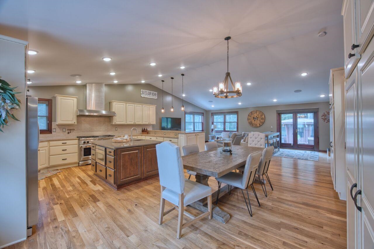 3557 Haverkamp Road Hibbing, MN 55746 - Photo 4 of 60 Dining area featuring light wood-style flooring, lofted ceiling, a chandelier, and recessed lighting