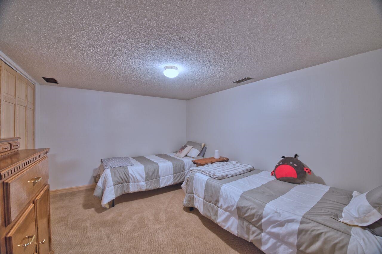3557 Haverkamp Road Hibbing, MN 55746 - Photo 39 of 60 Bedroom featuring light carpet and a textured ceiling