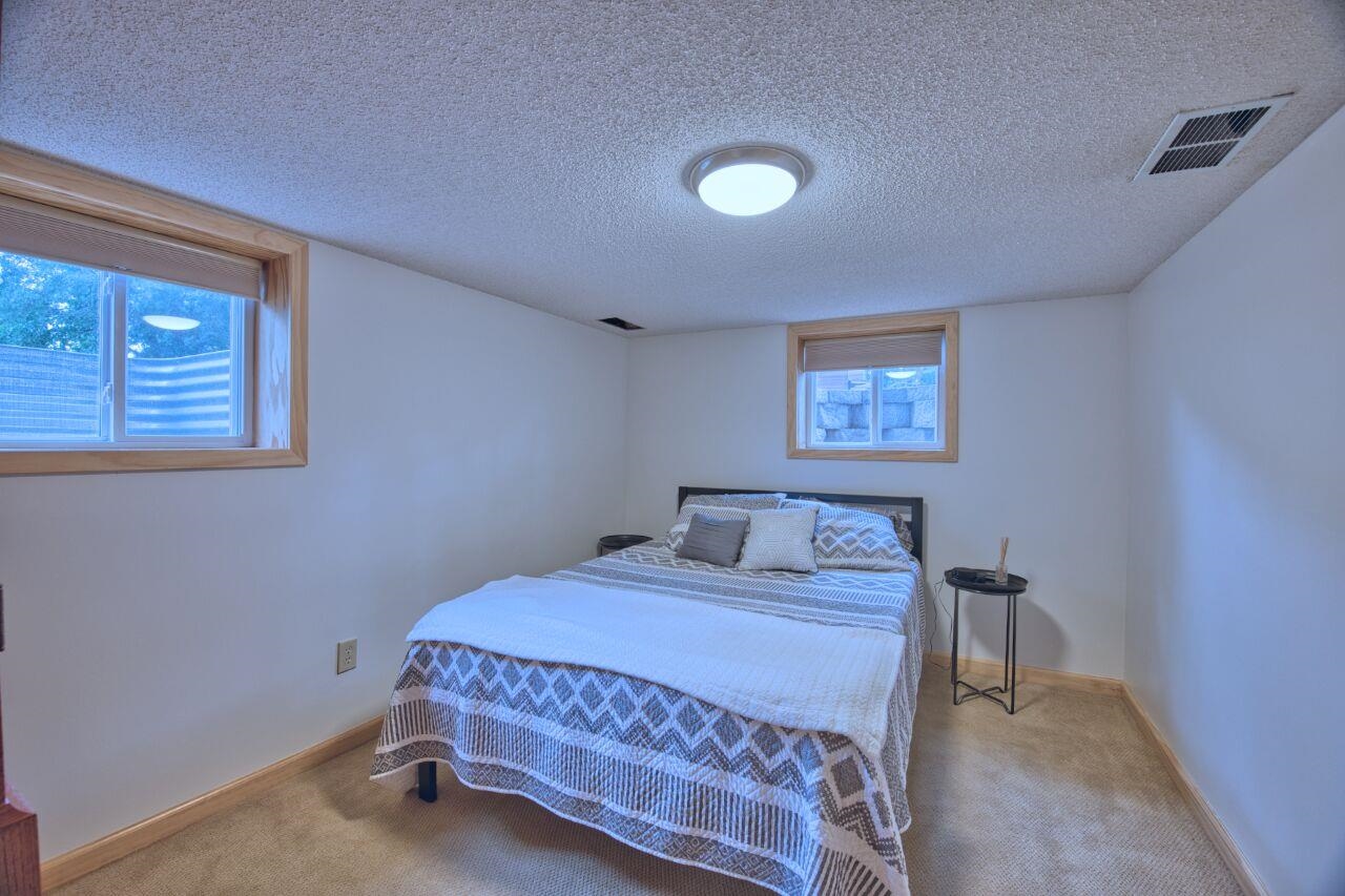 3557 Haverkamp Road Hibbing, MN 55746 - Photo 40 of 60 Carpeted bedroom featuring a textured ceiling and multiple windows