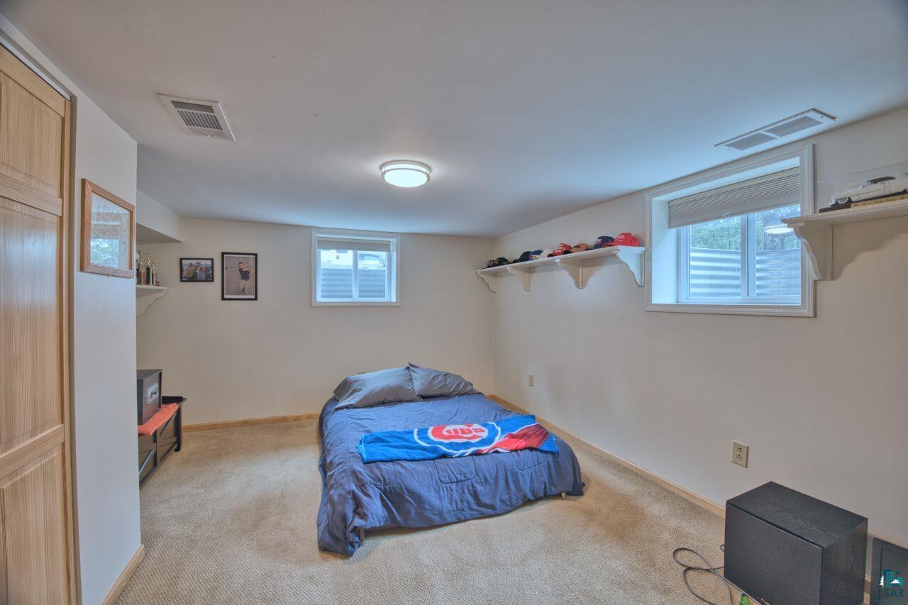 3557 Haverkamp Road Hibbing, MN 55746 - Photo 41 of 60 Bedroom with light carpet and multiple windows