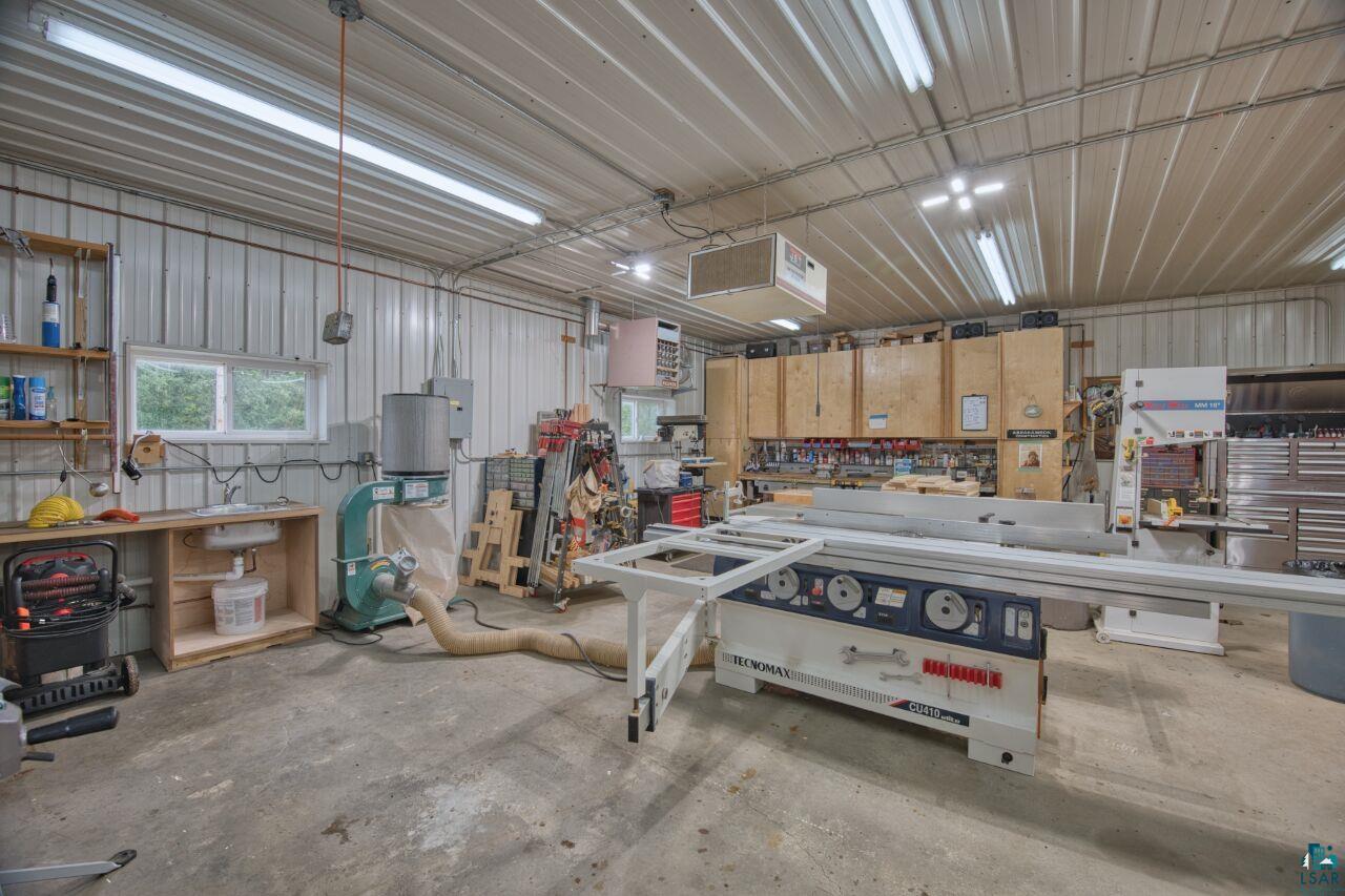 3557 Haverkamp Road Hibbing, MN 55746 - Photo 47 of 60 Garage with a workshop area, a heating unit, and metal wall