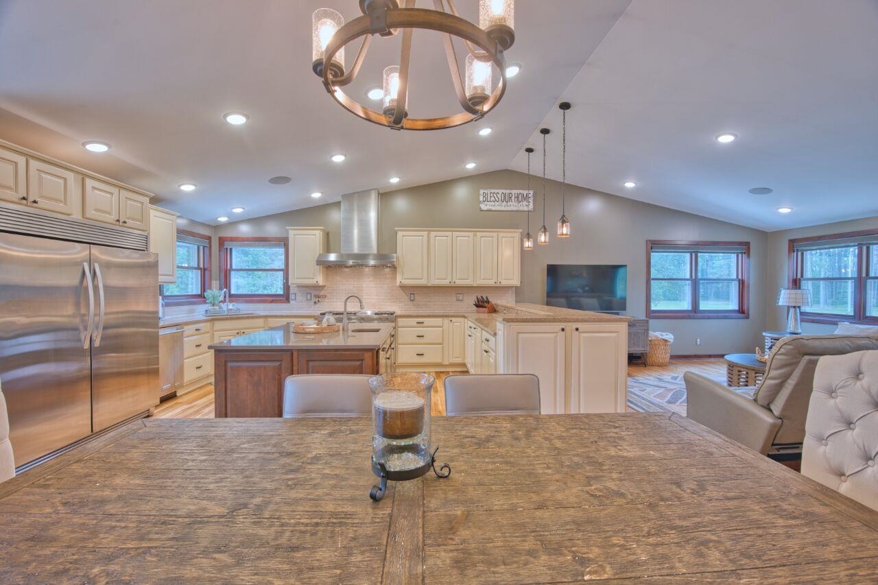 3557 Haverkamp Road Hibbing, MN 55746 - Photo 5 of 60 Dining space with a chandelier, lofted ceiling, light wood-style floors, and recessed lighting