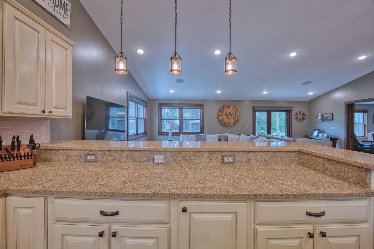 3557 Haverkamp Road Hibbing, MN 55746 - Photo 60 of 60 Kitchen with vaulted ceiling, recessed lighting, tasteful backsplash, open floor plan, and decorative light fixtures