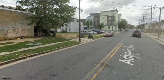 a view of a city street with tall buildings