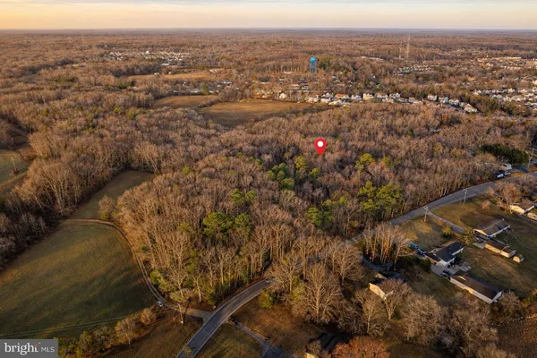 an aerial view of a residential houses with city view