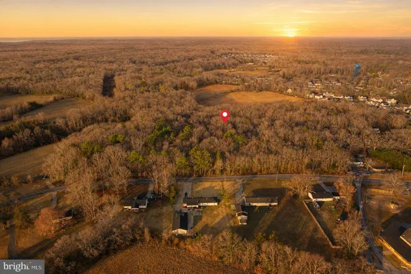 an aerial view of residential houses with city view