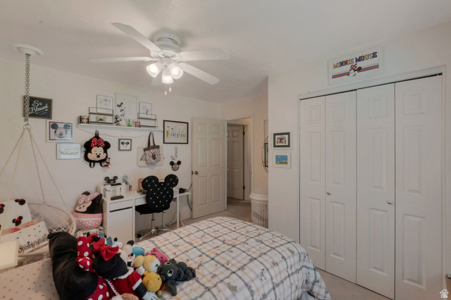 11072 Windy Peak Ridge Drive, Unit 32 Sandy, UT 84094 - Photo 19 of 30 Bedroom featuring a multi-panel bi-fold closet, neutral wall paint, and overhead ceiling fan with lighting