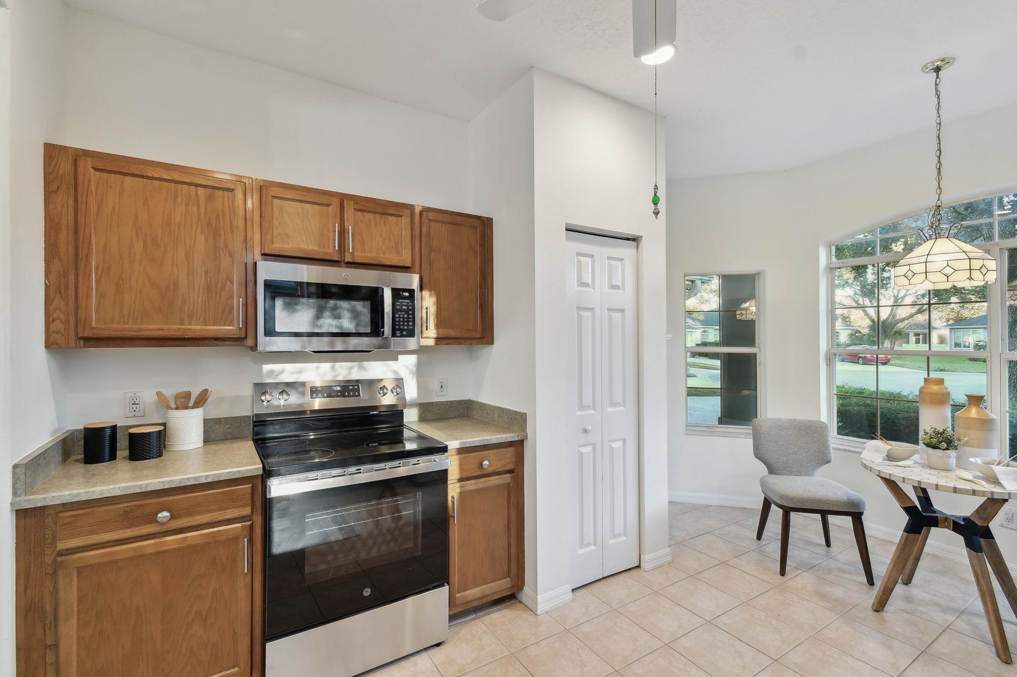 581 Boxwood Place St. Augustine, FL 32086 - Photo 12 of 44 a kitchen with stainless steel appliances a stove a sink and a microwave