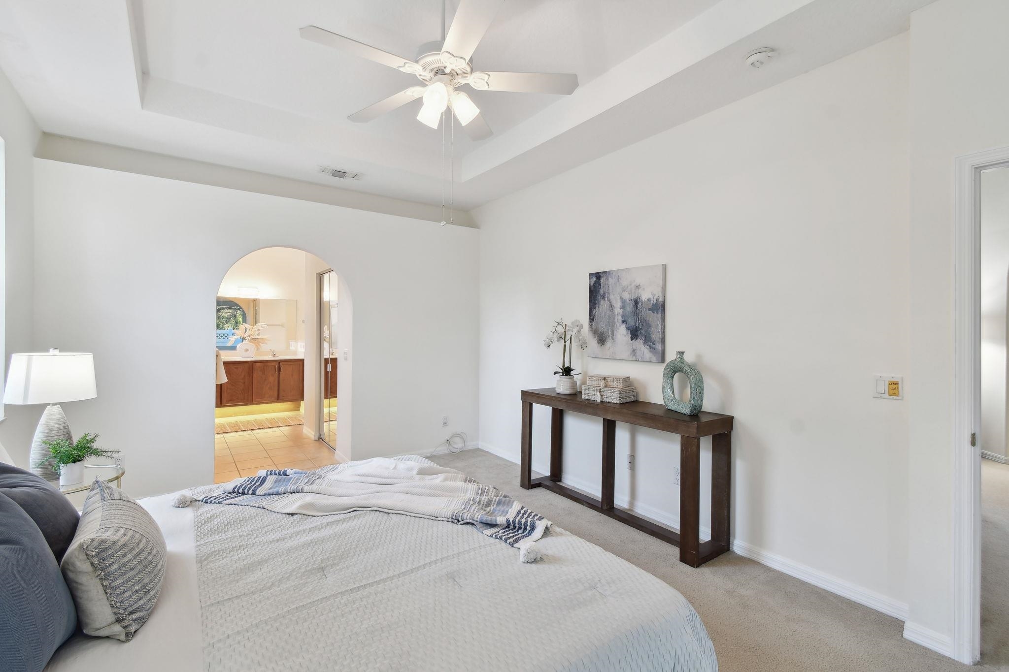 581 Boxwood Place St. Augustine, FL 32086 - Photo 19 of 44 a bedroom with a bed and a chandelier
