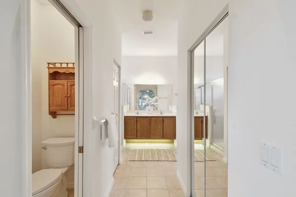 a view of a livingroom with a ceiling fan and entryway