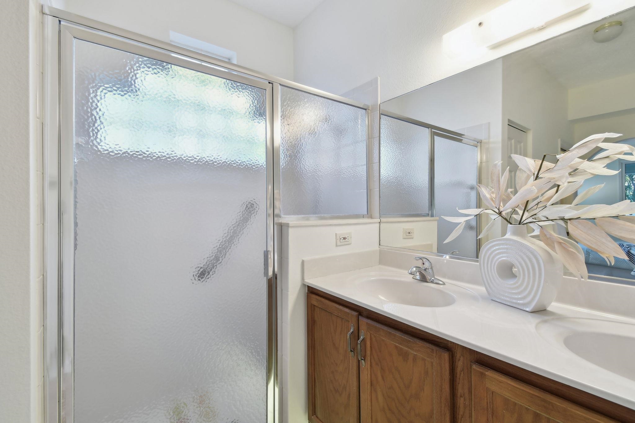 581 Boxwood Place St. Augustine, FL 32086 - Photo 24 of 44 a bathroom with a double vanity sink and mirror