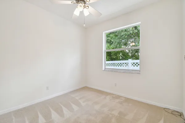 a front view of a house with a garden and trees