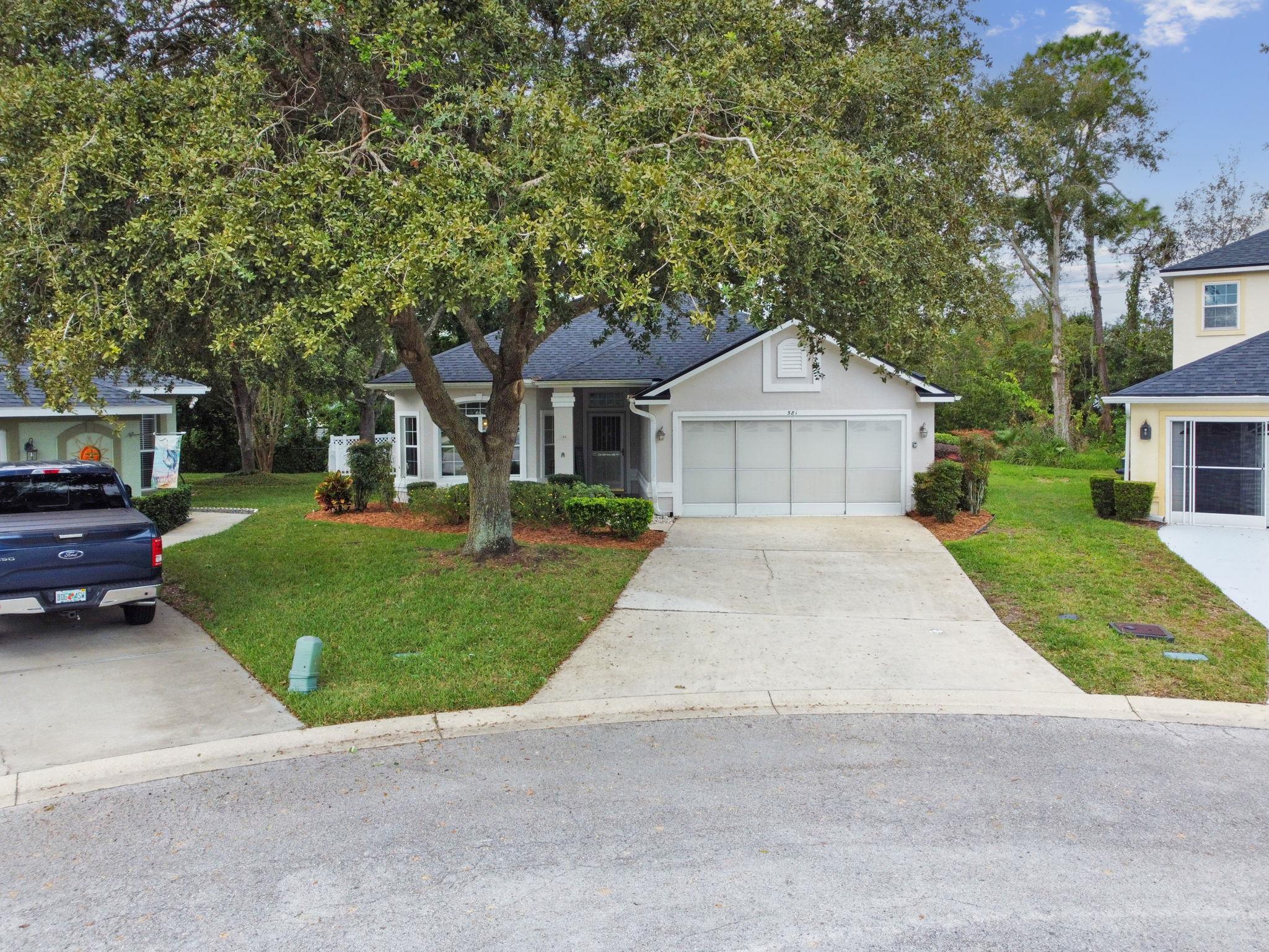 581 Boxwood Place St. Augustine, FL 32086 - Photo 37 of 44 a front view of a house with a garden and trees