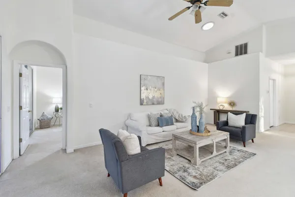 a view of a dining room with furniture and chandelier