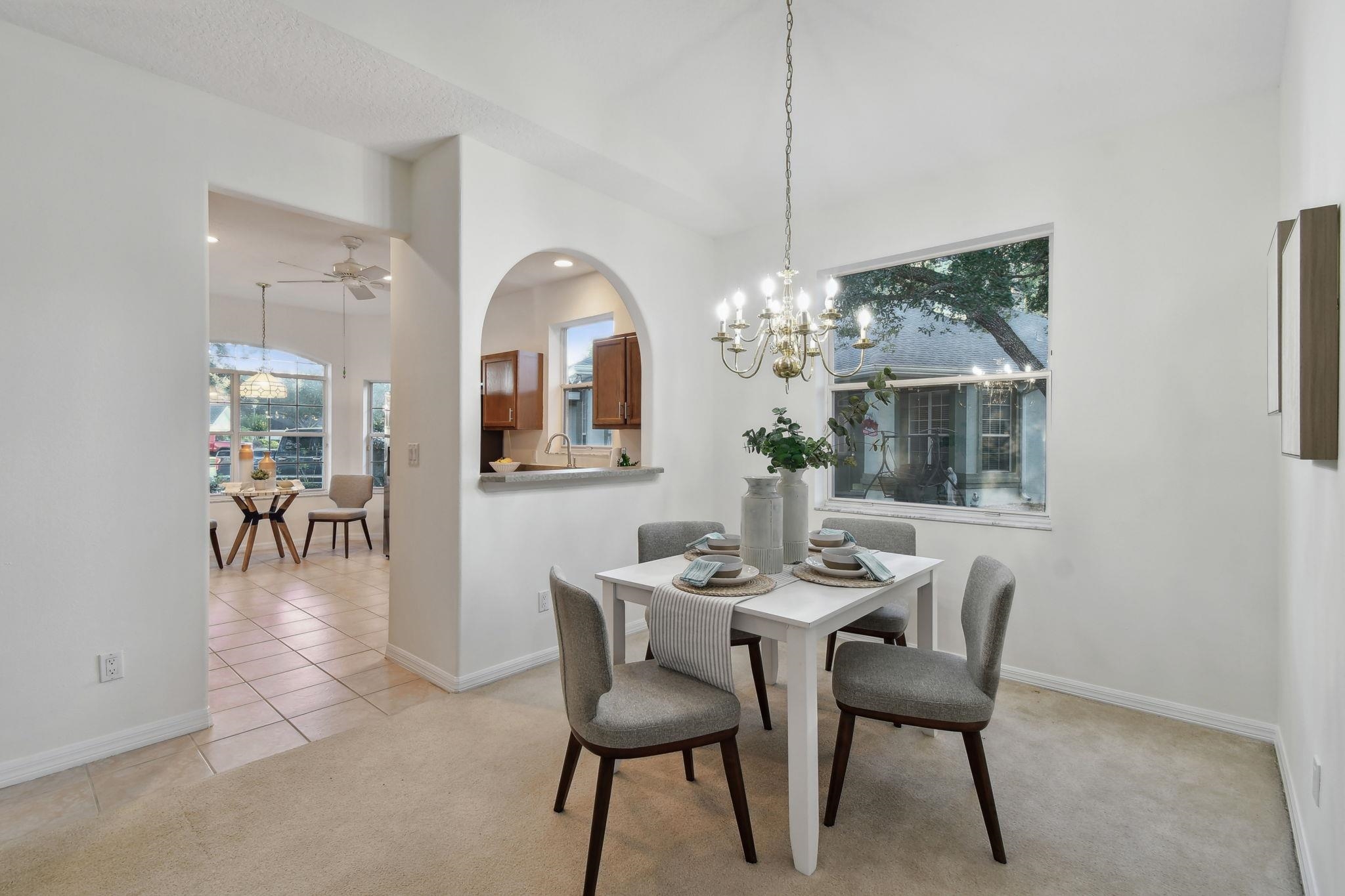 581 Boxwood Place St. Augustine, FL 32086 - Photo 6 of 44 a view of a dining room with furniture and chandelier