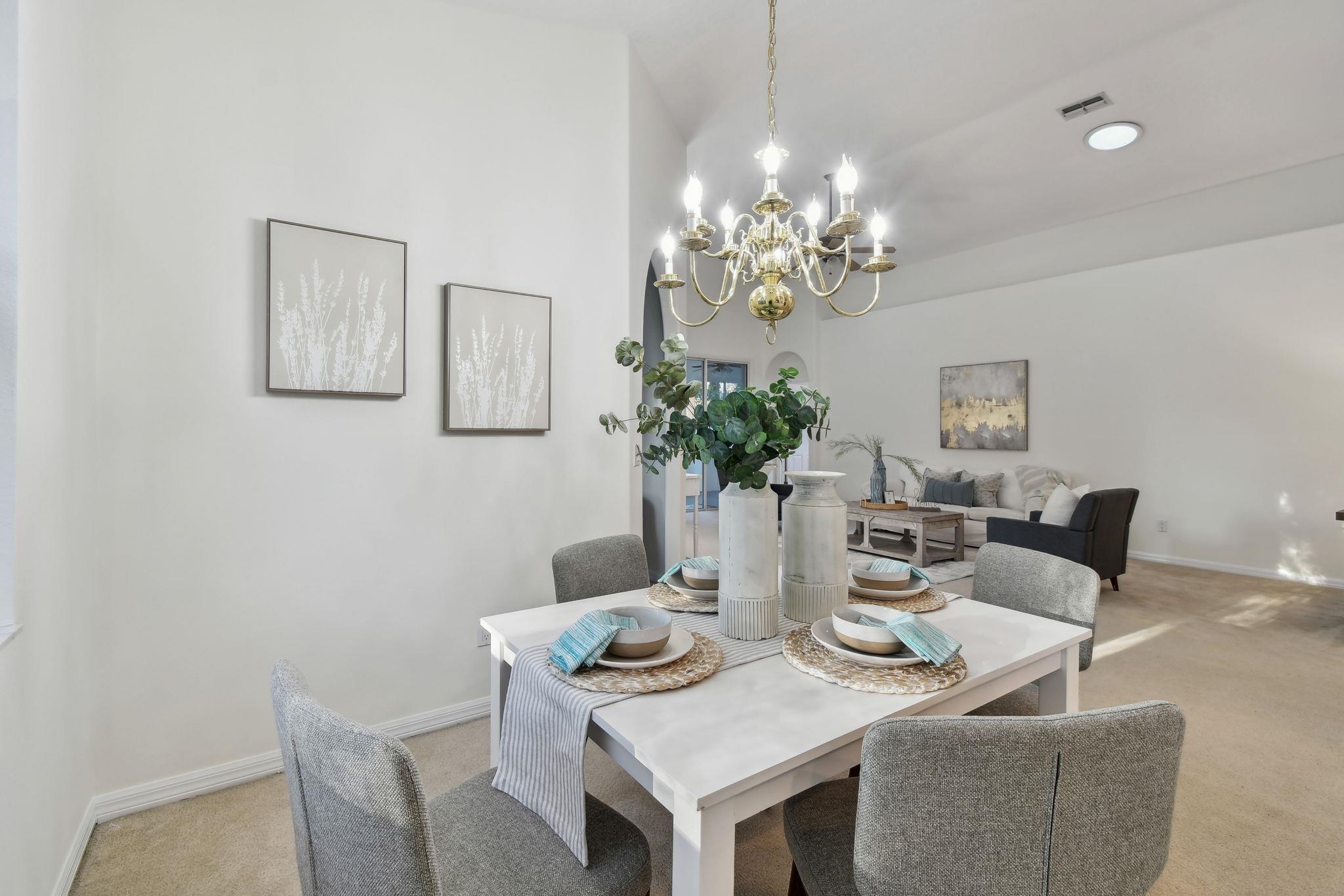 581 Boxwood Place St. Augustine, FL 32086 - Photo 7 of 44 a view of a dining room with furniture and chandelier
