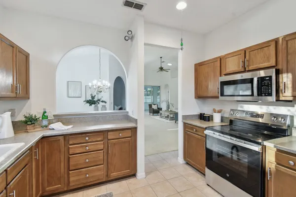a open kitchen with stainless steel appliances granite countertop a sink and a refrigerator