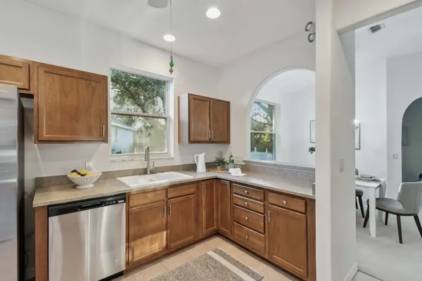 a kitchen with stainless steel appliances a stove a sink and a microwave