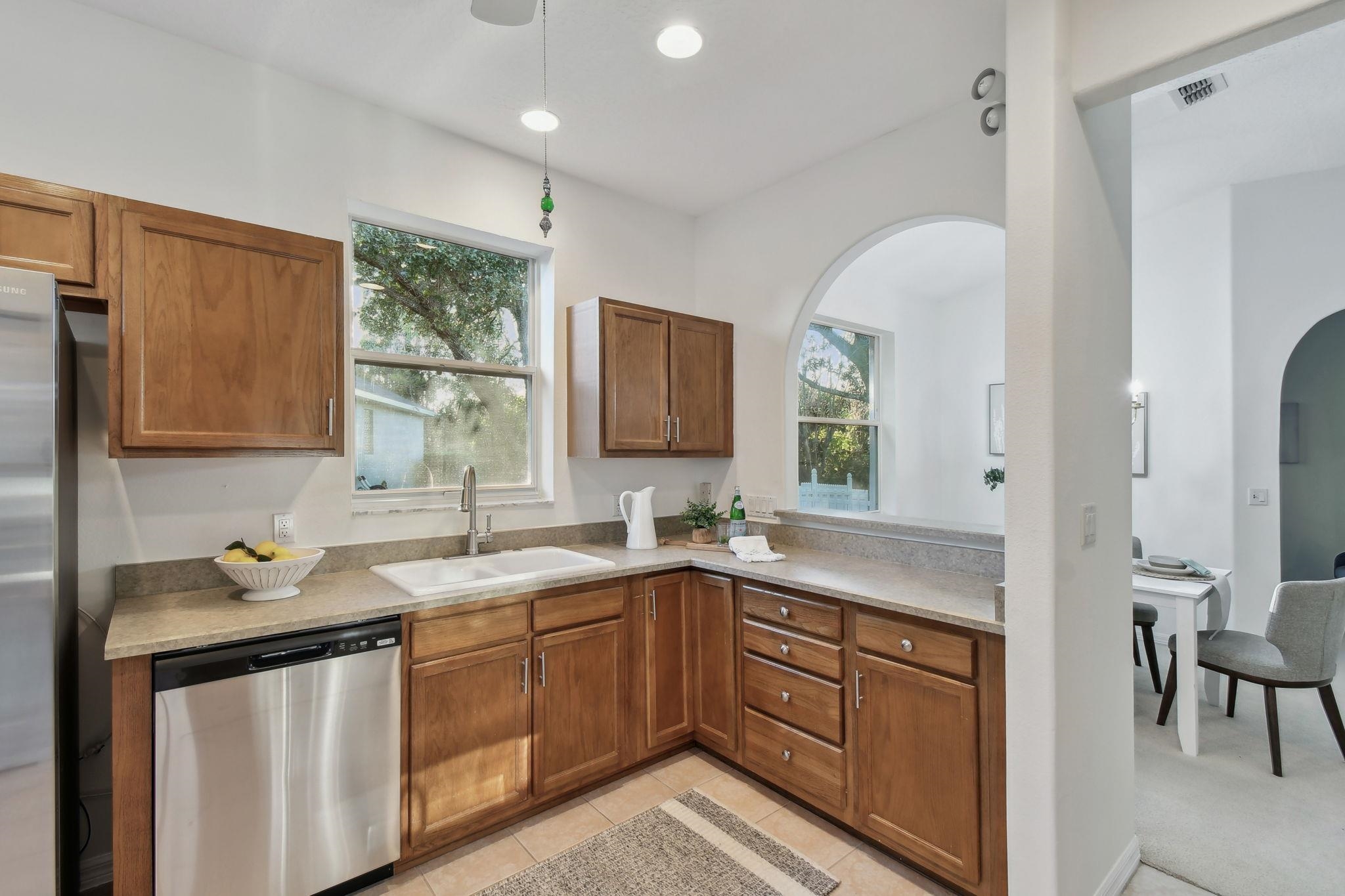 581 Boxwood Place St. Augustine, FL 32086 - Photo 9 of 44 a kitchen with a sink stove and cabinets