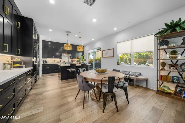 a kitchen with stainless steel appliances kitchen island granite countertop a stove a sink and a refrigerator