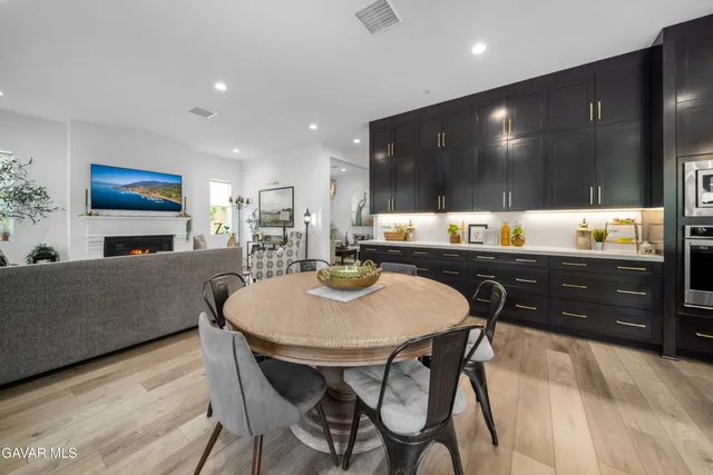 a kitchen with a sink cabinets and wooden floor