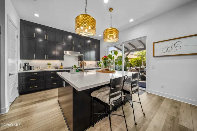 a kitchen with stainless steel appliances granite countertop a sink stove and cabinets
