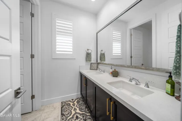a view of a workspace with a bookshelf and a window