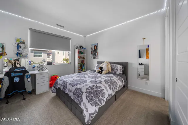 a bedroom with a large bed and a couch