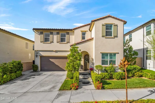 a view of staircase with lots of frames on wall and a wooden floor