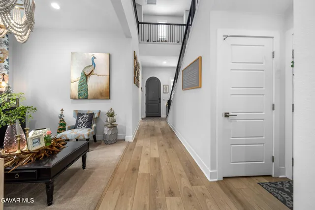 a living room with furniture a chandelier and a window