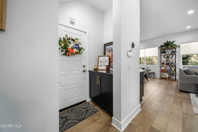 a living room with furniture fireplace and a large window