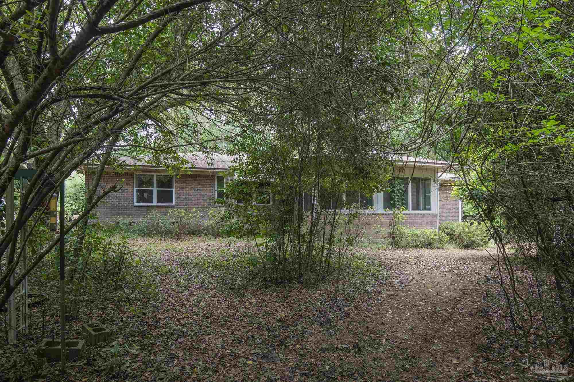 1210 Goldenrod Road Cantonment, FL 32533 - Photo 45 of 50 a view of a house with a yard