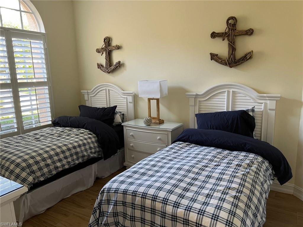 6840 Bent Grass Drive Naples, FL 34113 - Photo 12 of 21 a bedroom with a bed and window