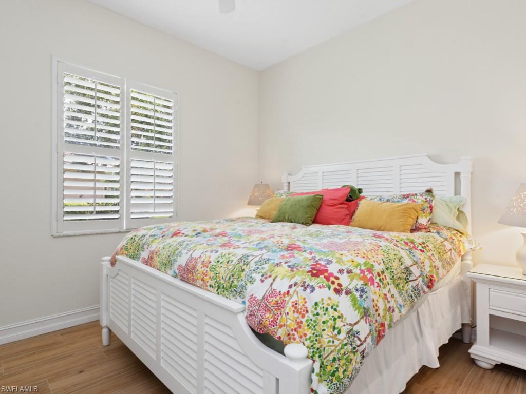 6840 Bent Grass Drive Naples, FL 34113 - Photo 13 of 21 a bedroom with a bed and a window