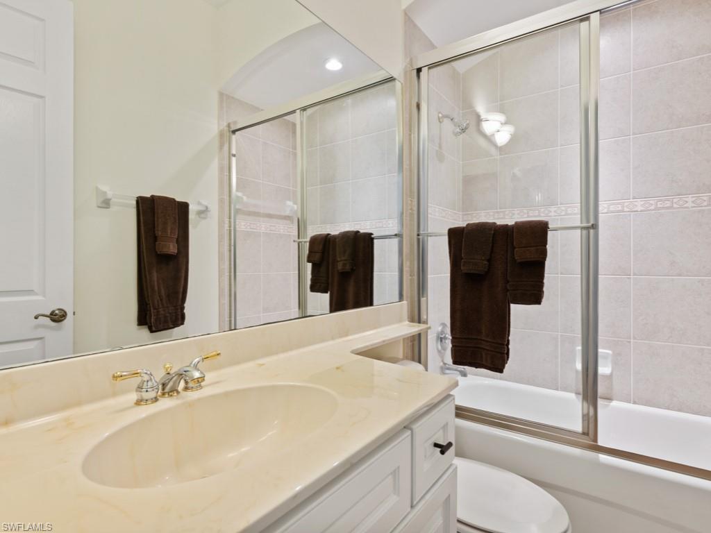 6840 Bent Grass Drive Naples, FL 34113 - Photo 14 of 21 a bathroom with a sink a toilet and shower