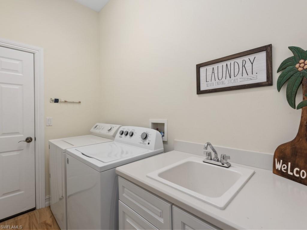 6840 Bent Grass Drive Naples, FL 34113 - Photo 15 of 21 a utility room with dryer and washer
