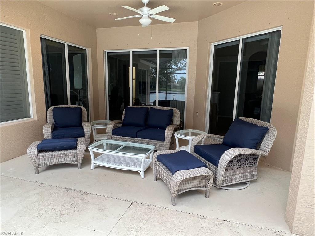 6840 Bent Grass Drive Naples, FL 34113 - Photo 16 of 21 a outdoor living space with furniture and a large window