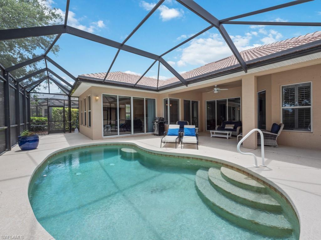6840 Bent Grass Drive Naples, FL 34113 - Photo 17 of 21 a swimming pool with outdoor seating and yard