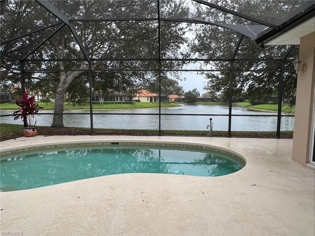 6840 Bent Grass Drive Naples, FL 34113 - Photo 19 of 21 a view of a swimming pool with a yard