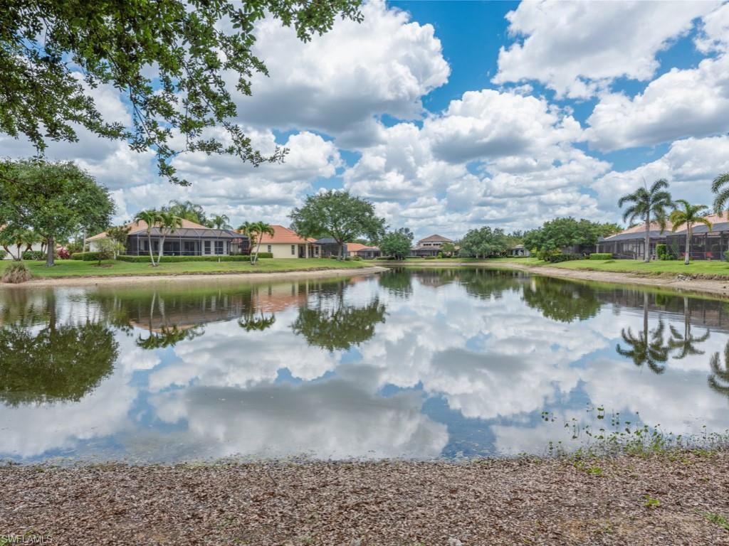 6840 Bent Grass Drive Naples, FL 34113 - Photo 20 of 21 a view of a lake with a big yard