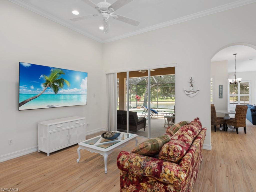 6840 Bent Grass Drive Naples, FL 34113 - Photo 2 of 21 a living room with furniture and wooden floor