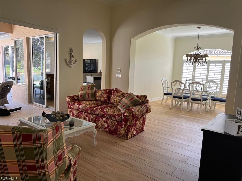6840 Bent Grass Drive Naples, FL 34113 - Photo 3 of 21 a living room with furniture and a wooden floor