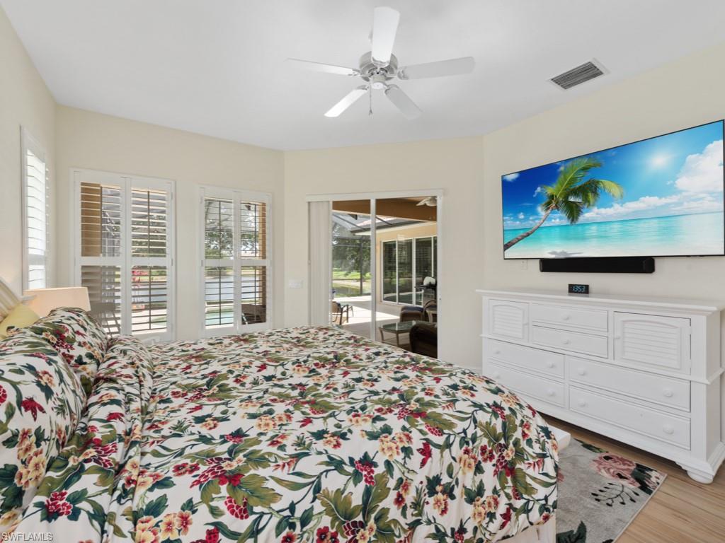 6840 Bent Grass Drive Naples, FL 34113 - Photo 9 of 21 a bed room with a bed tv and a window