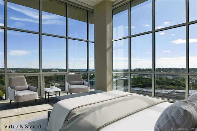 a bed room with a bed and a large window