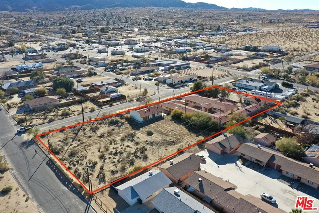 an aerial view of residential house and sandy dunes