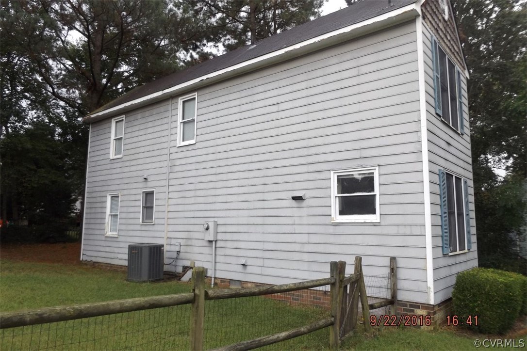 11101 Timonium Drive Chester, VA 23831 - Photo 15 of 18 a view of a white house with a small yard and a large tree