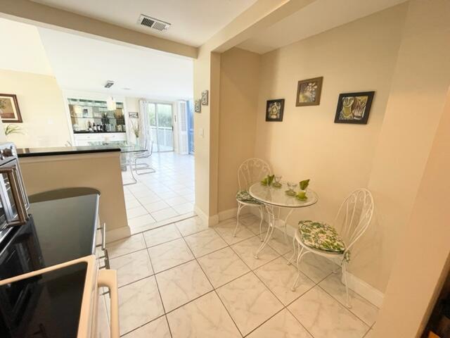 2780 South Ocean Boulevard, Unit 312 Palm Beach, FL 33480 - Photo 11 of 29 a living room with a couch and a stove