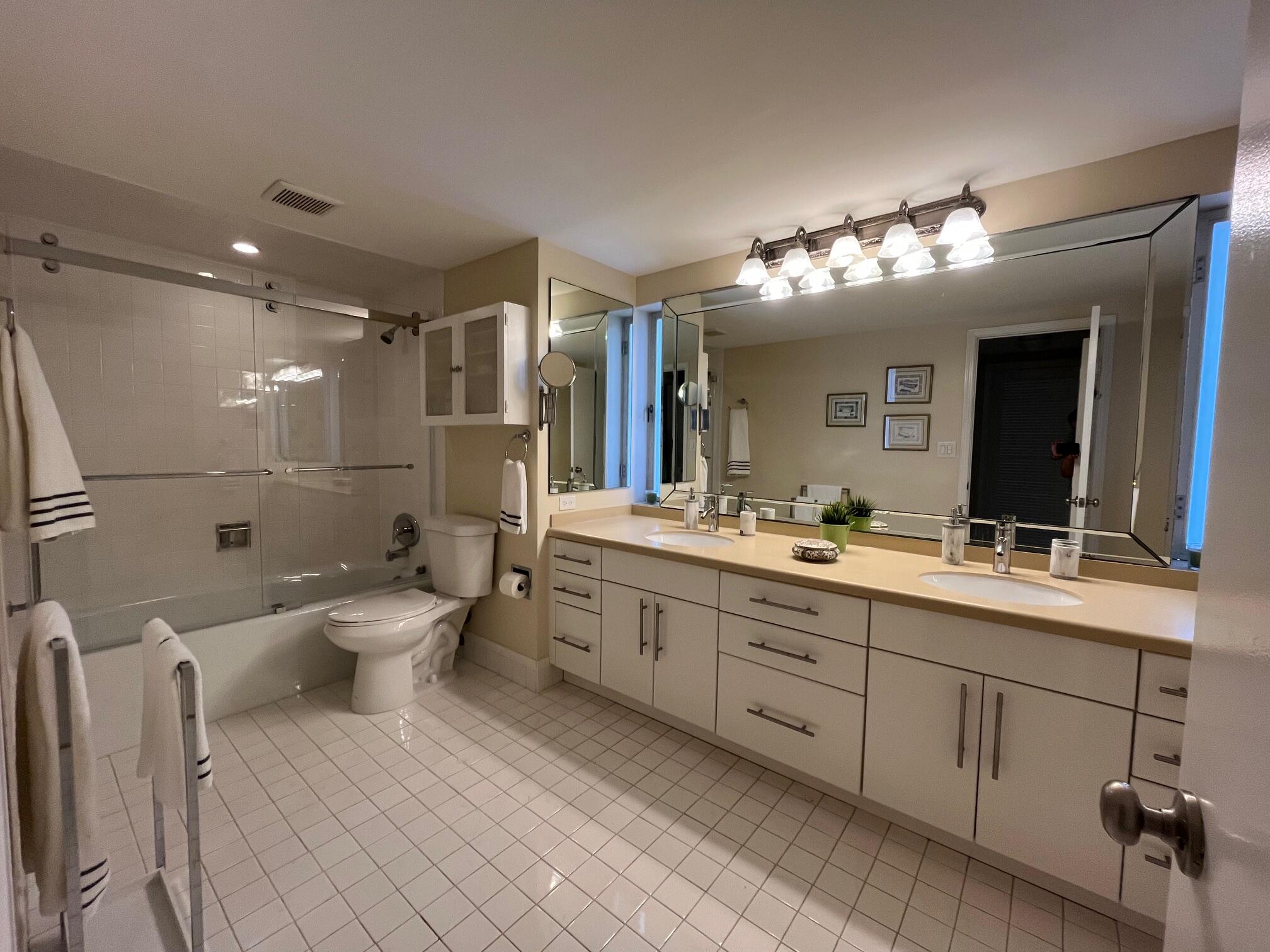 2780 South Ocean Boulevard, Unit 312 Palm Beach, FL 33480 - Photo 13 of 29 a bathroom with a double vanity sink toilet and a mirror