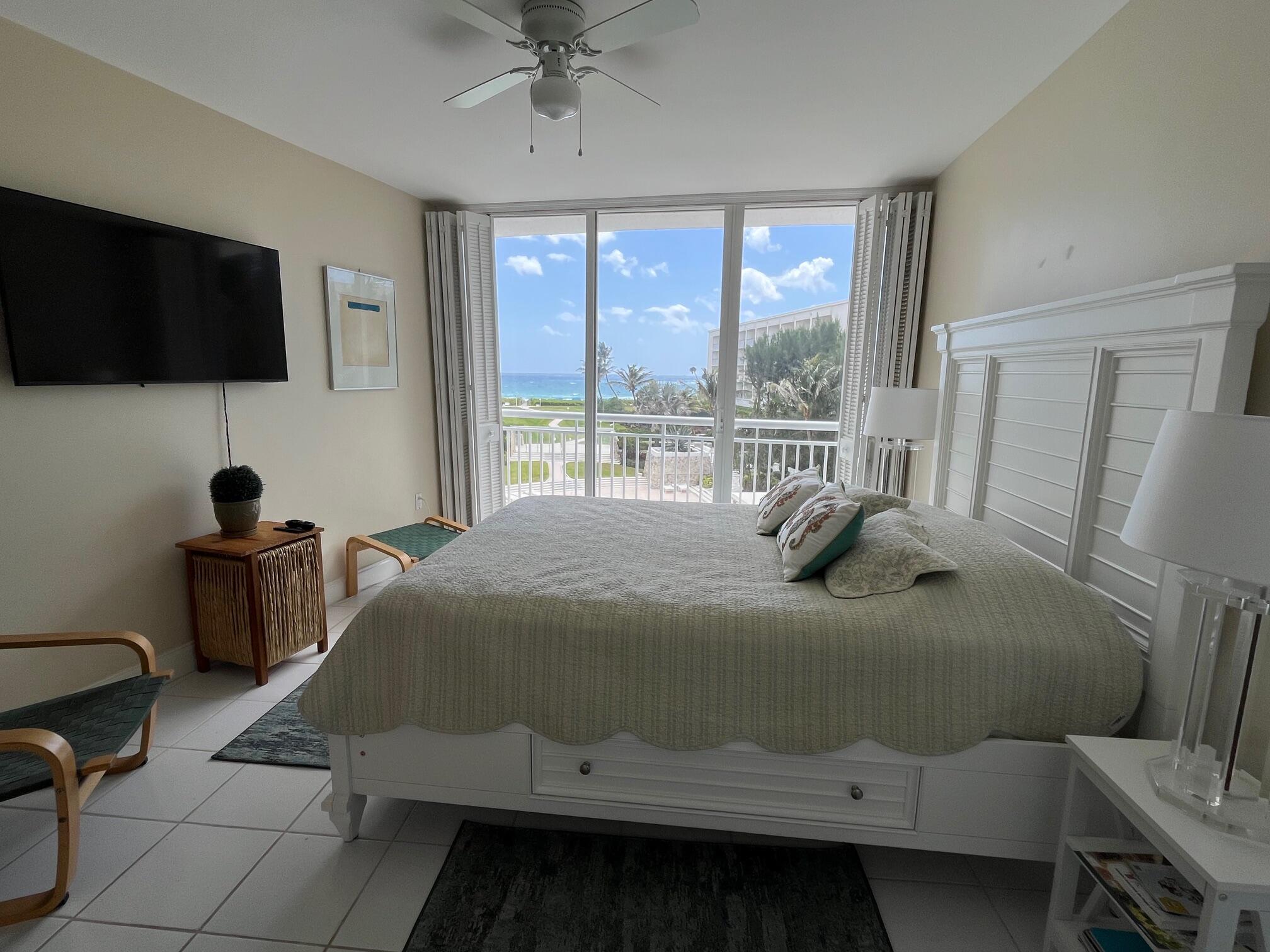 2780 South Ocean Boulevard, Unit 312 Palm Beach, FL 33480 - Photo 14 of 29 a bedroom with a bed and a flat tv screen on the table